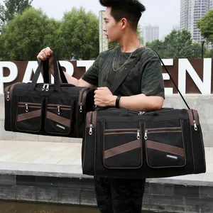 Grande borsa da viaggio in nylon nero con cinturini marroni e multitasche