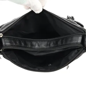 Top view of black washed leather crossbody bag showing multi-pocket interior storage