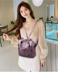 Deep purple sheepskin textured leather backpack for women shown in a casual lifestyle setting