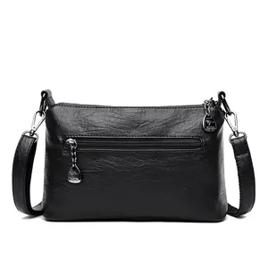 Bolso tipo cubo vintage de cuero negro con cremalleras plateadas y correa ajustable