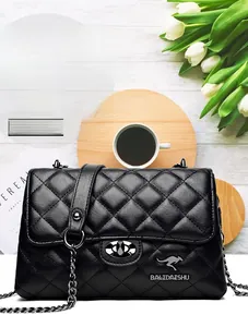 Flat lay of black quilted leather chain bag with coffee and flowers lifestyle scene