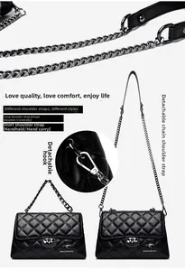 Detail view of black quilted leather crossbody bag with detachable chain strap and logo