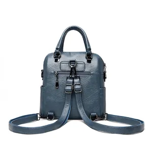 Dark blue sheepskin leather backpack with crossbody straps and rear anti-theft zipper pocket