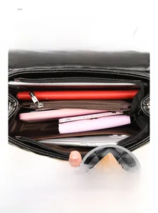 Internal compartments of the black quilted chain bag showing ample storage and back pocket