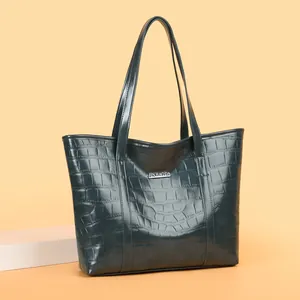 Deep greyish-green crocodile embossed leather tote bag with silver logo plaque