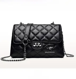 Detailed view of the diamond quilted leather texture and metal twist lock on the black bag