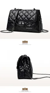 Detail of the quilted black shoulder bag showing the shiny texture and metal chain strap