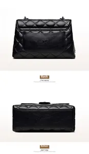 Detail view of the quilted leather texture and logo embossing on the bag back and bottom