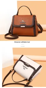 Detail of crocodile pattern leather bag with kangaroo logo and magnetic flap closure