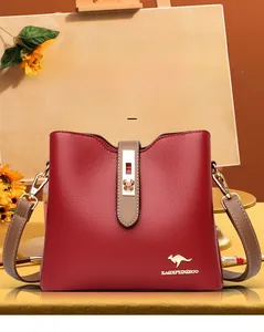 Close-up of red lychee pattern leather bucket bag with gold lock and kangaroo logo