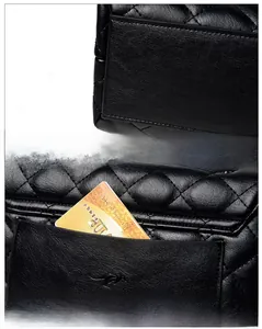 Detail of black quilted leather shoulder bag featuring precise stitching and back pocket