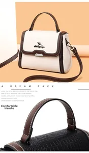 Detail showing the crocodile-embossed texture and sturdy handle of the large tote bag