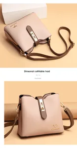 Detail showing the golden kangaroo logo and premium lychee grain leather on a pink bucket bag