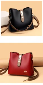 Macro detail of lychee grain leather bucket bag with retro metal lock and brand logo