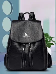 Detail view of black lychee grain leather backpack featuring fringe zippers and metal logo