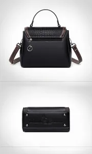 Detail view of crocodile-patterned shoulder bag showing the zip pocket and metal base studs