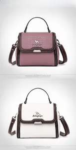 Detail of crocodile pattern textured shoulder bag with kangaroo logo and handle