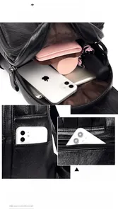Detail of black pebbled leather backpack showing inner compartments and anti-theft back pocket