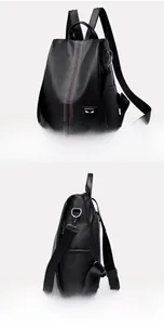Detail of black lychee grain backpack featuring stitched monster eyes and silver hardware