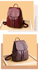 Close-up of wine red and purple faux leather backpacks with metal kangaroo logo and tassels