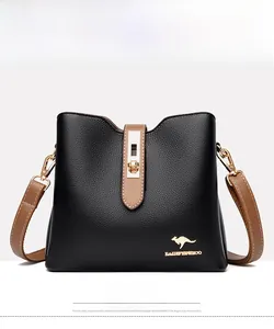 Detail of lychee pattern leather bucket bag with gold kangaroo logo and brown strap