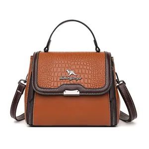 Brown crocodile embossed top-handle doctor bag with kangaroo logo and crossbody strap