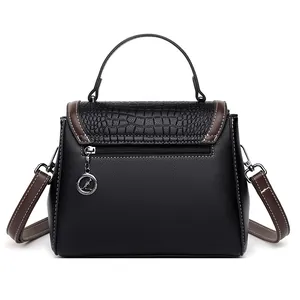 Black crocodile embossed tote bag with brown trim and metal charm, rear view