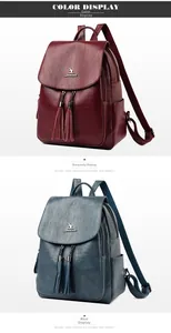 Close-up of wine red and blue textured leather backpacks with dual tassel zippers