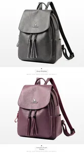 Detail view of large soft leather backpacks in gray and taro purple with fringe zippers