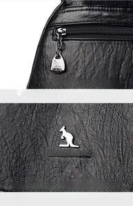 Close-up of black lychee grain leather texture with premium metal kangaroo logo