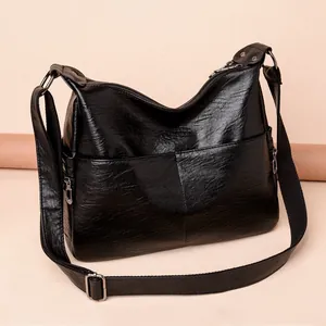 Classic black crossbody bag in washed sheepskin texture with multiple zipper pockets
