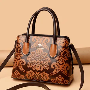 Vintage handtas met bloemenpatroon in bruin met dubbele hengsels en gouden details