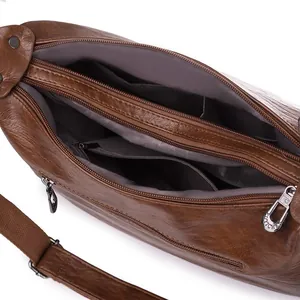 Classic brown crossbody bag with multi-zipper compartments and textured pebble finish