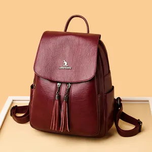 Deep red leather backpack for women with tassels and metallic kangaroo logo detail