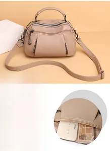 Detailed interior of beige boston bag showing spacious capacity for cosmetics and daily items