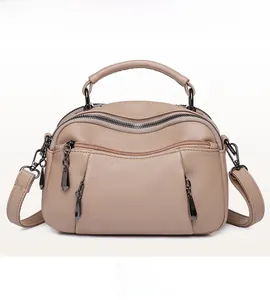 Detailed front view of khaki leather boston bag featuring double zippers and pebbled texture