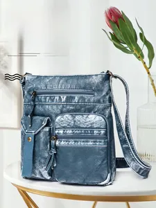 Detail of vintage blue washed leather bucket bag with multi-pocket and silver hardware