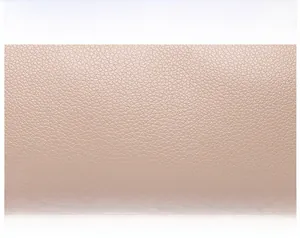Detailed close-up showing soft pink pebble grain leather texture with premium stitching