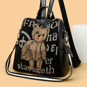 Fashionable black leather backpack with sparkling rhinestone bear and embroidery patterns