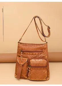 Detail of vintage brown leather bucket bag showing functional multi-pocket design