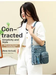 Close-up of a blue denim multi-pocket crossbody bucket bag on a fashion model
