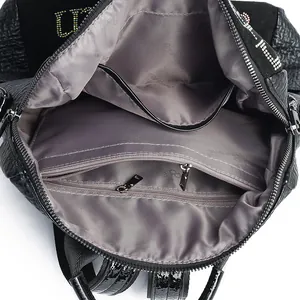 Top view of leather backpack with satin lining, internal zipper pocket and rhinestone logo