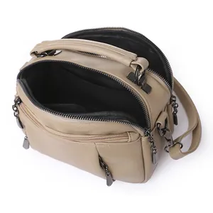 Litchi pattern leather Boston bag with multiple zippers and detachable shoulder strap