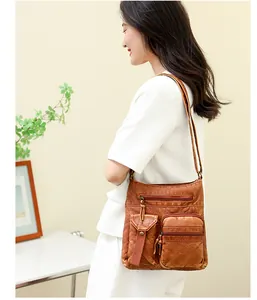 Close-up of vintage brown denim leather bucket bag with multi-pocket texture details