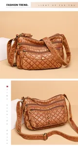 Detail view of vintage brown crossbody bag with quilted stitching and multiple zip pockets