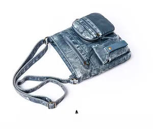 Detail of vintage blue washed PU leather bucket bag featuring multiple pockets and metal hardware