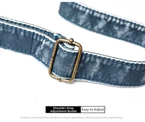 Detail of adjustable denim-texture shoulder strap with vintage bronze buckle on bucket bag