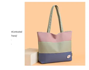 Close-up of color block canvas bucket bag featuring pink and blue patchwork detail