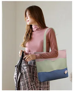 Close-up of a large tricolor patchwork tote bag with pink, green and blue wave panels