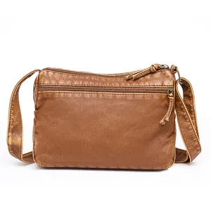 Vintage brown washed leather crossbody bag with front zipper and tassel detail